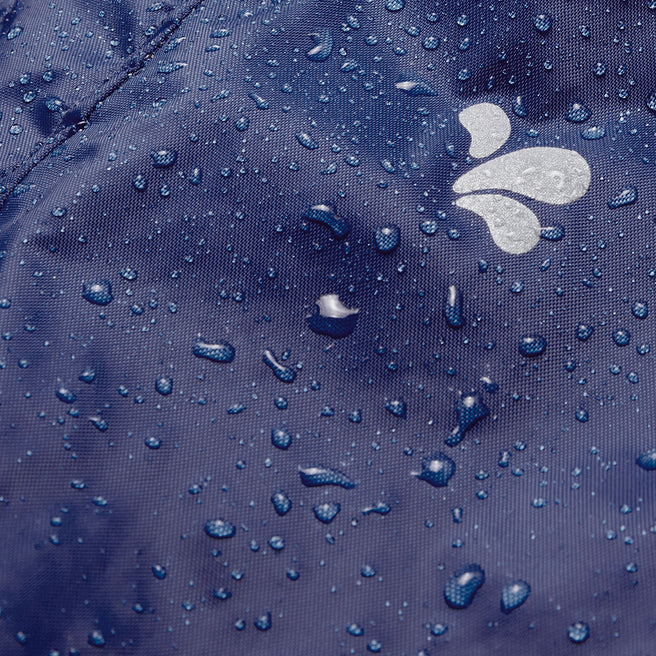 Close-up of navy Originals Waterproof Dungarees fabric, covered in water droplets and featuring the brand logo.